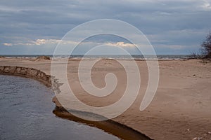 Small river delta among sandy dunes by Baltic sea