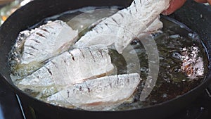 Small river fish is fried on a hike or fishing in camp pan