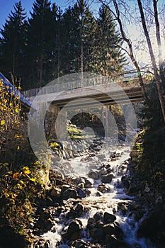 A small river flowing under a bridge in Ecrins National Parl