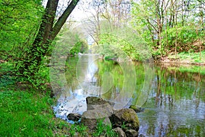 Small river and green banks in spring