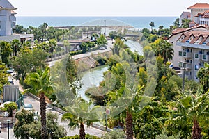 Small river among hotels flowing to Mediterranean sea in Evrenseki, Side, Turkey