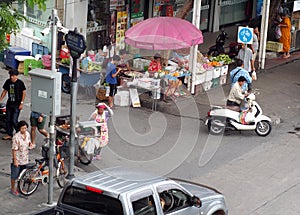 Small road to main street junction corner everyday life scene in BANGKOK, THAILAND