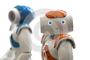 Small robots with human face and body. AI photo