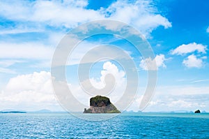 Small rock island near Koh Lanta, Krabi Thailand on clear blue s