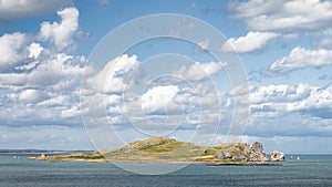 Small rocky island called Irelands Eye with Martello Tower