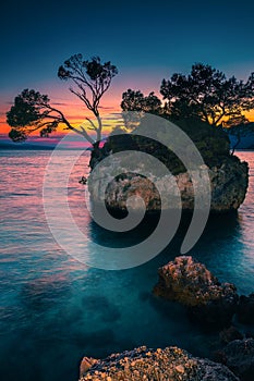 Small rocky island in the sea at sunset, Brela, Croatia