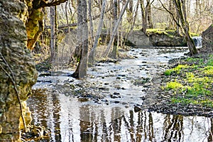 A small rocky river in a rural area in early spring