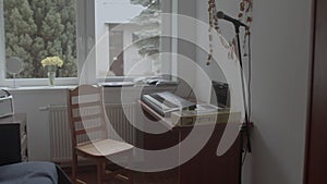 Small room with synthesizer and microphone. Online vocal lessons, remote work.