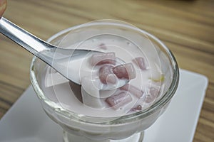 Small round balls made from taro mixed with tapioca flour with sweet coconut milk, Thai dessert called Bualoy photo