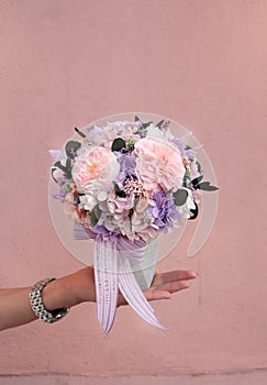 Small round flower box in hands. Magic flowers box. Preserved flowers. roses and Hydrangea.