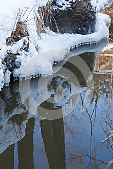 Small round icicles over water