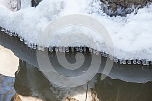 Small round icicles over water