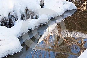 Small round icicles over water