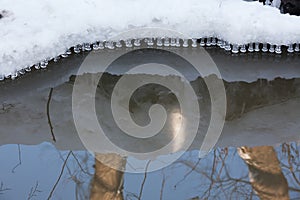Small round icicles over water