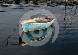 Small rowing boat on calm water photo
