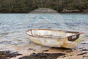 Small rowing boat moored on the beach