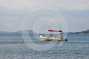 Small rubber motor boat, dinghy in morning light