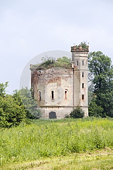 Small ruined abandoned castle overgrown in vegetation