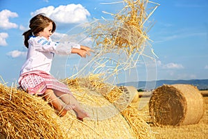Small rural girl on harvest field