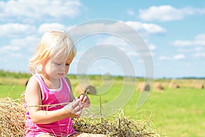 Small Rural Girl On Straw After Harvest