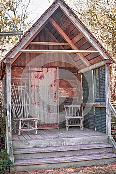 Small Rustic House with Wooden Chairs on Porch