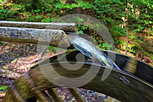 Small rustic watermill producing energy