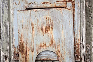 Small rusty hatch in door