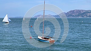 Small sail boat rocking in the ocean