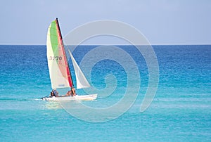 Small sailboat in a calm blue sea