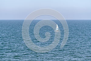 Small sailboat on calm sea water