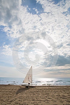 Small sailboat on a cart at the beach