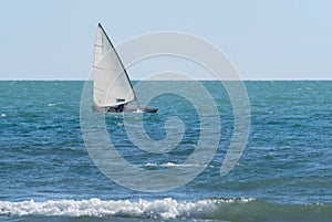 Small sailboat sailing in a windy day