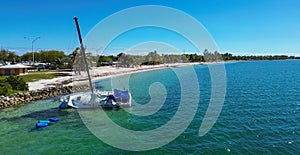 Small sailboat stranded on Biscayne Beach near Miami