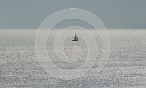 Small Sailing Boat on the Ocean. Sea during a calm Day
