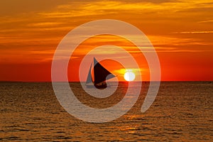 Small sailing boat at the sunset. Boracay, Philippines