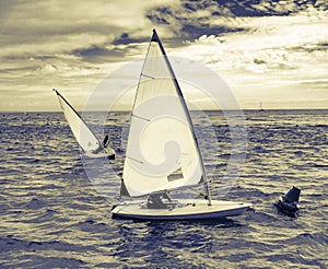 Small sailing boats rounding a buoy off the Dorset coast