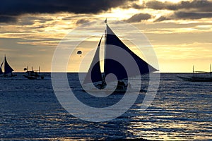 Small sailing boats at the sunset. Boracay, Philippines