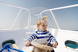 Small sailor on boat. summer vacation. childhood happiness. funny kid in striped marine shirt. journey discovery