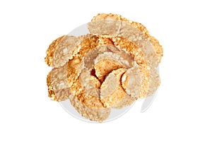 Small sampling of corn flake cereal in a pile isolated against a white background