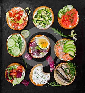 Small sandwiches on black rustic background