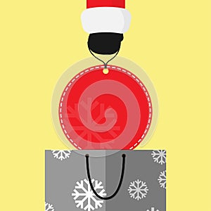 Small Santa clause hand lift big round red price tag from gray shopping bag. background vector design