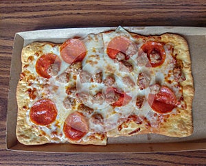 Small sausage and pepperoni flatbread pizza