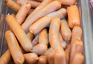 Small sausages or frankfurters at refrigerated store window