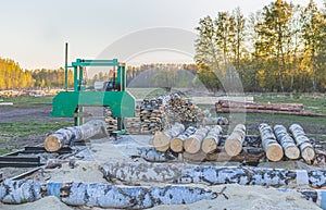 A small sawmill for processing wood in the countryside. Aspen logs.