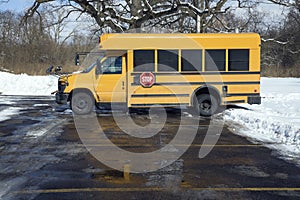 Small school bus on the parking lot