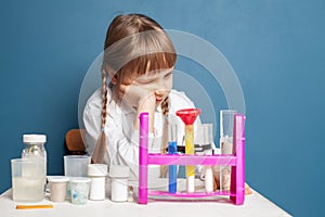 Small school child girl studying science