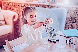Small schooler choosing what chemistry element using photo