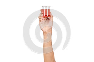 Small science beaker with red water or red liquid holding by boy hand isolated on white background. Hand showing science beaker in