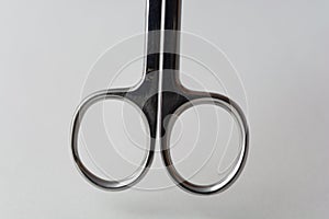 Small scissors on a grey background soft light