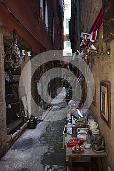 A small selection of trinkets and crockery in an off street in Venice, Italy.